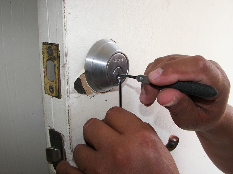 residential locksmith miami beach expert inspecting coastal home door lock